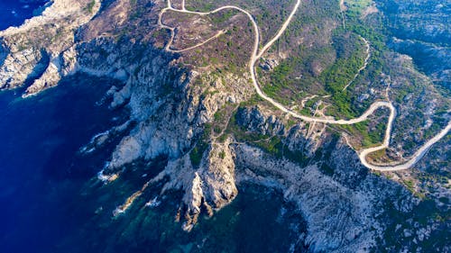 Aerial Footage of a Rocky Coast and Road Meanders