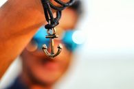 Selective Focus Photography of Anchor Pendant