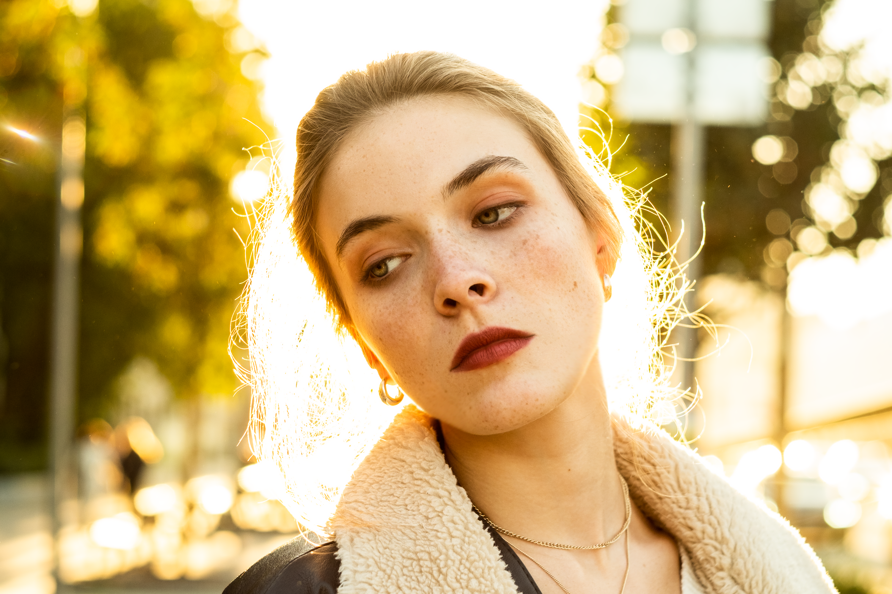 Beautiful Young Woman Wearing a Jacket Posing Outdoors · Free Stock Photo