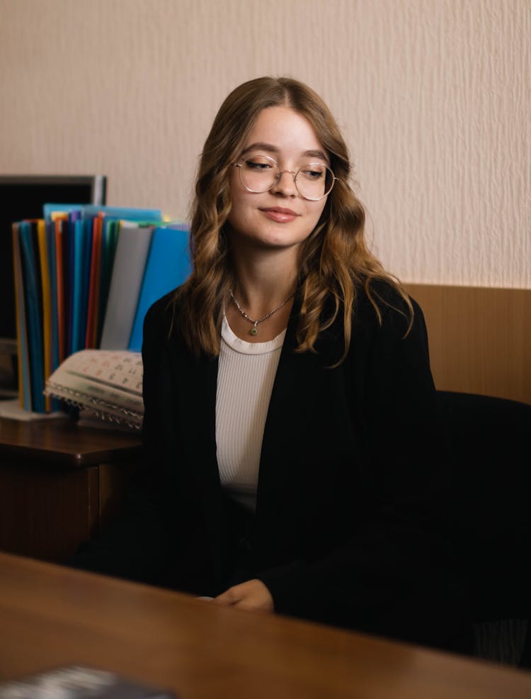 A Woman Wearing Eyeglasses And Black Blazer