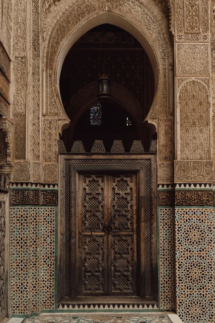 Beautiful Moroccan door with traditional Islamic patterns and mosaic tiles in Fes, Morocco.