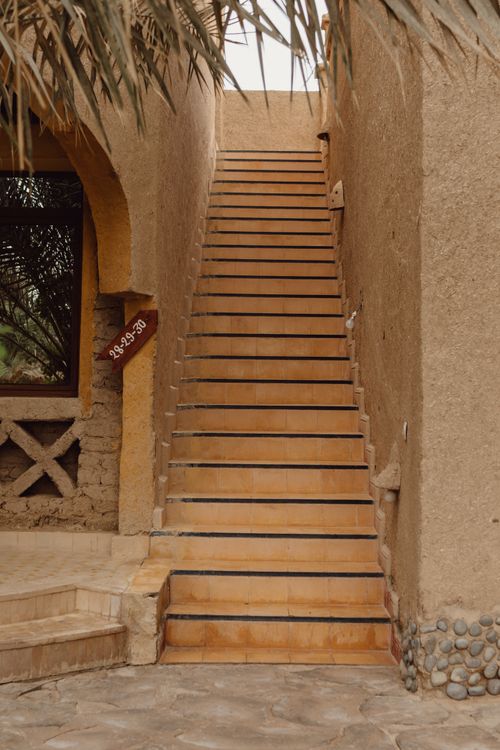 Free A serene staircase leading to a tropical resort room, captured in warm tones. Stock Photo