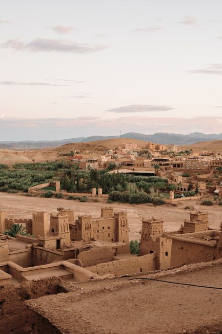 Explore the serene beauty of a historic desert town during sunset, capturing its unique architecture.