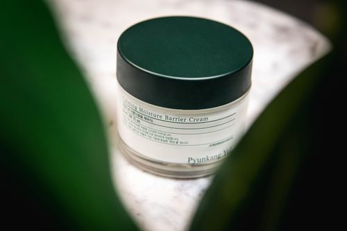 Free Close-up of Pyunkang Yul Calming Moisture Barrier Cream displayed on a marble surface. Stock Photo