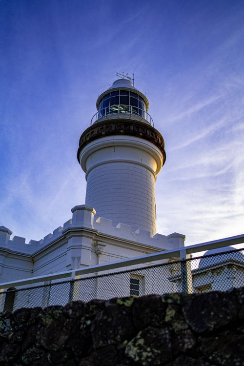 Free Stunning low angle view of a lighthouse against a vibrant evening sky. Ideal for travel and architecture themes. Stock Photo