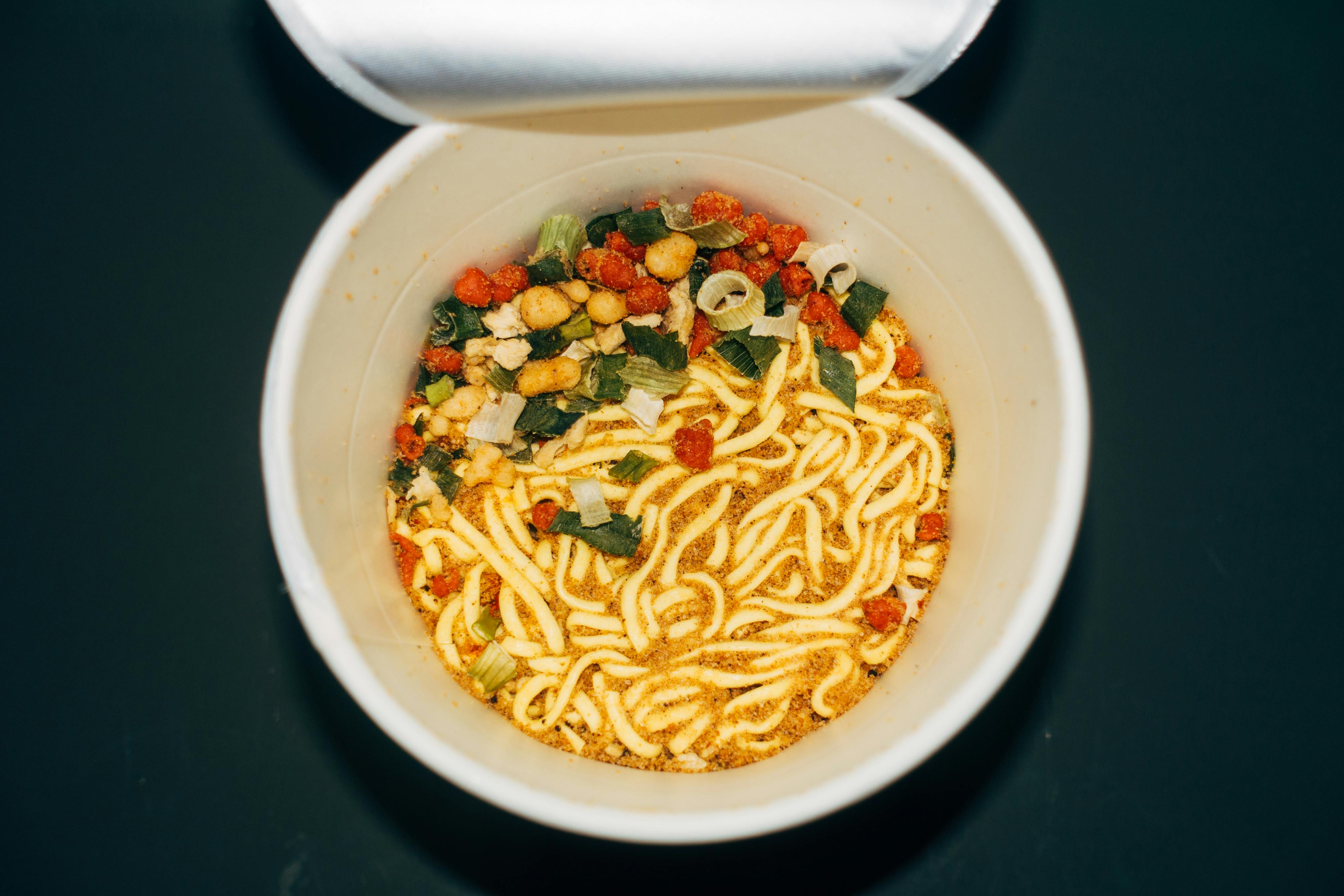 noodles with vegetables in white ceramic bowl