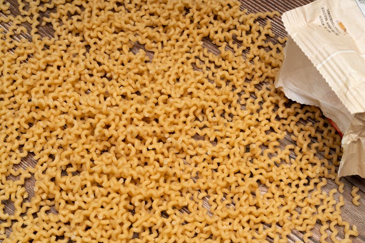 Uncooked Spiral Pasta On A Wooden Surface