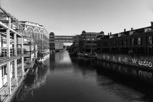 Free Black and white urban scene of buildings along a canal in Leipzig, Germany. Stock Photo