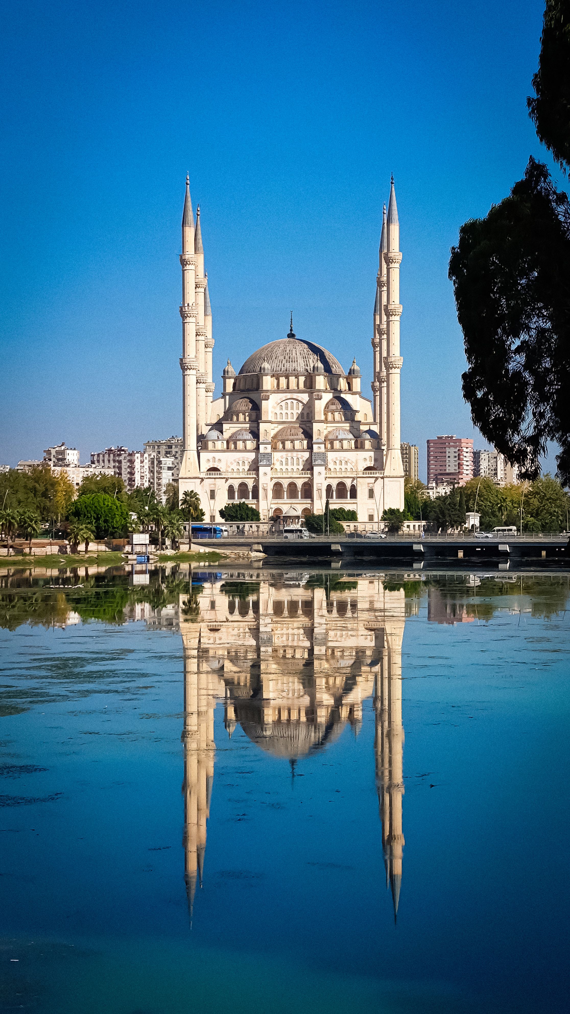 Stunning view of Sabanci Central Mosque and its reflection in the Seyhan River, Adana, Turkey.