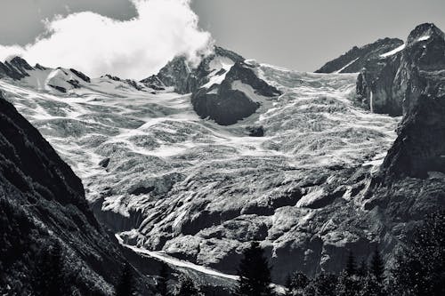 Grayscale Photo of Snow-Covered Mountains 