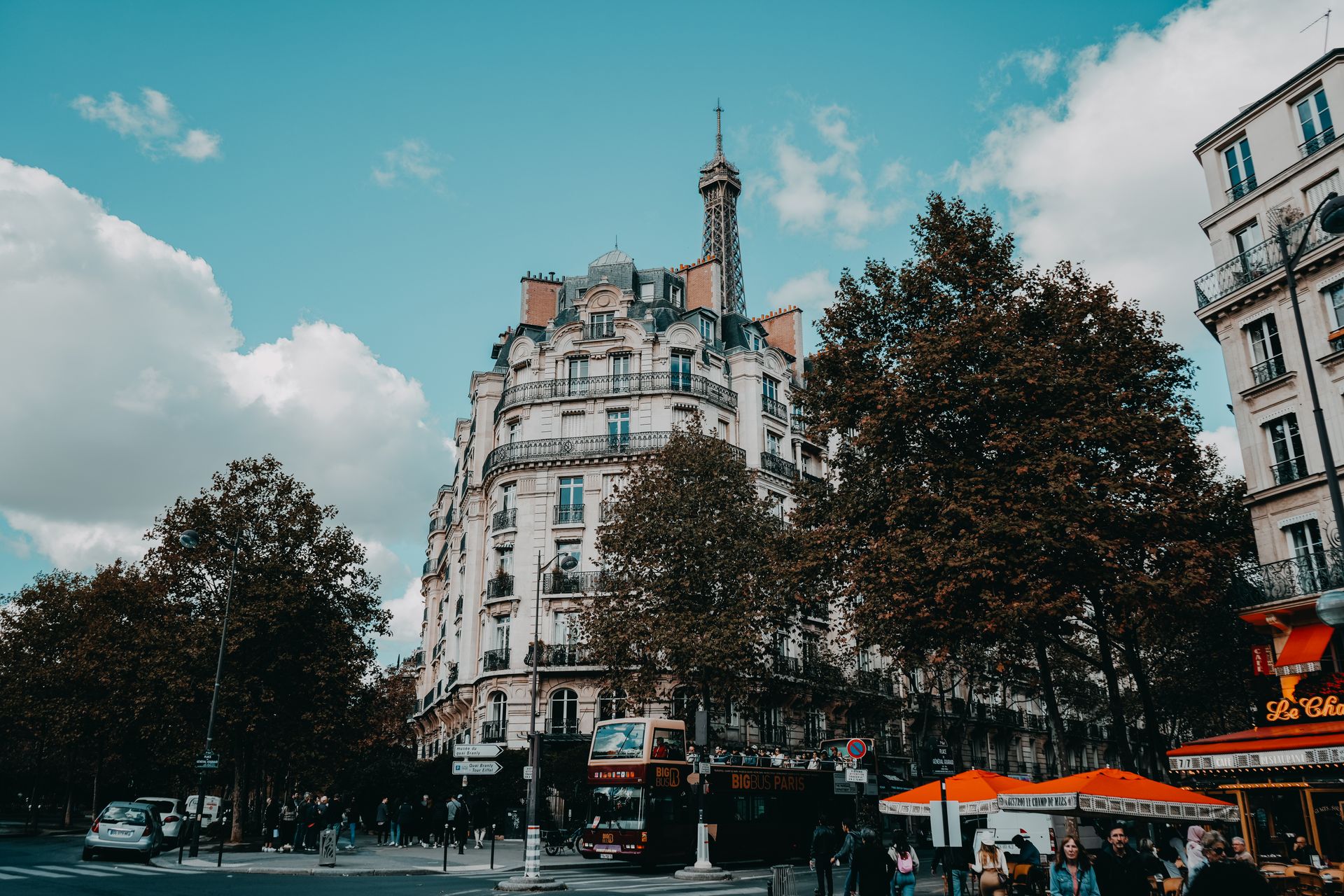 Charming urban street scene in Paris with classic architecture and the Eiffel Tower.