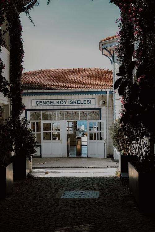 Free A picturesque entrance framed by flowers leads to Çengelköy İskele, a notable landmark in Istanbul. Stock Photo