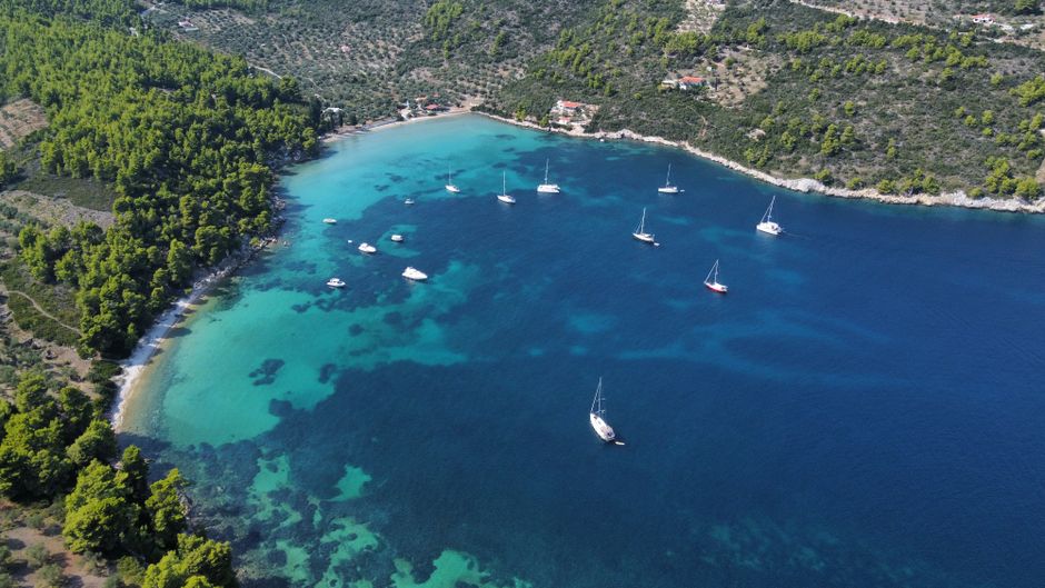 Unforgettable Full Day Naxos Exploration Yacht Tour Review: 7 Hours of Greek Island Paradise Review 2026 - Aerial photograph of a tranquil Greek coastal bay with boats and lush greenery.