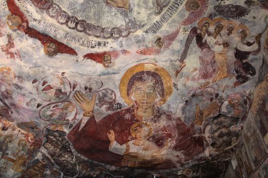 Detailed religious fresco showcasing sacred figures and spiritual themes on a wall.