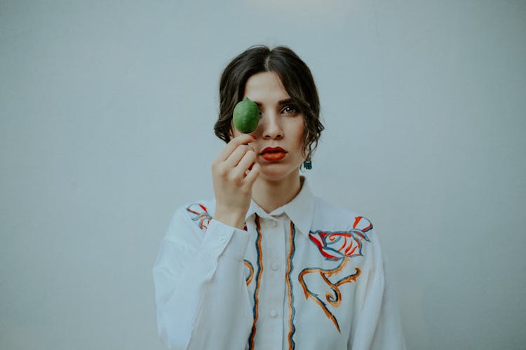 Young Woman Holding A Lime Against Her Eye