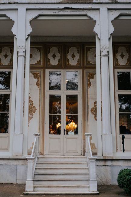 A charming facade of an antique building highlighting its ornate details and elegant porch.