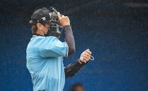 A Man Wearing a Catcher Helmet