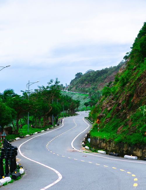 Free Beautiful winding road through lush greenery in Da Nang, Vietnam, perfect for travel and adventure enthusiasts. Stock Photo