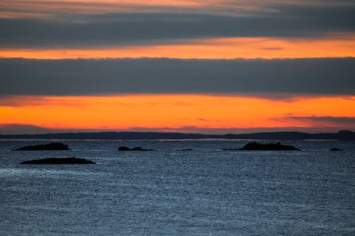 Free Clouds on Orange Sky over Sea Stock Photo