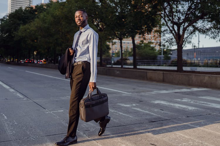 Businessman In Suit Crossing On Street Crosswalk