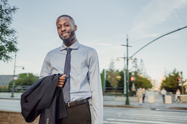 Smiling Man In Suit Posing On Street