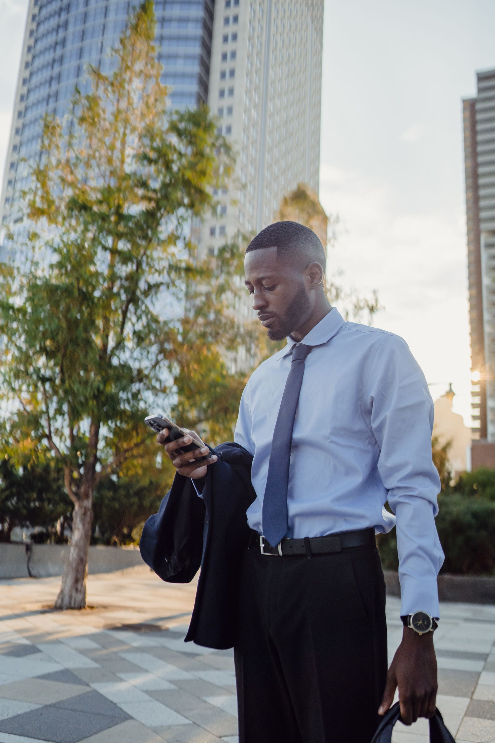 Profissional empresarial usando smartphone em área urbana moderna