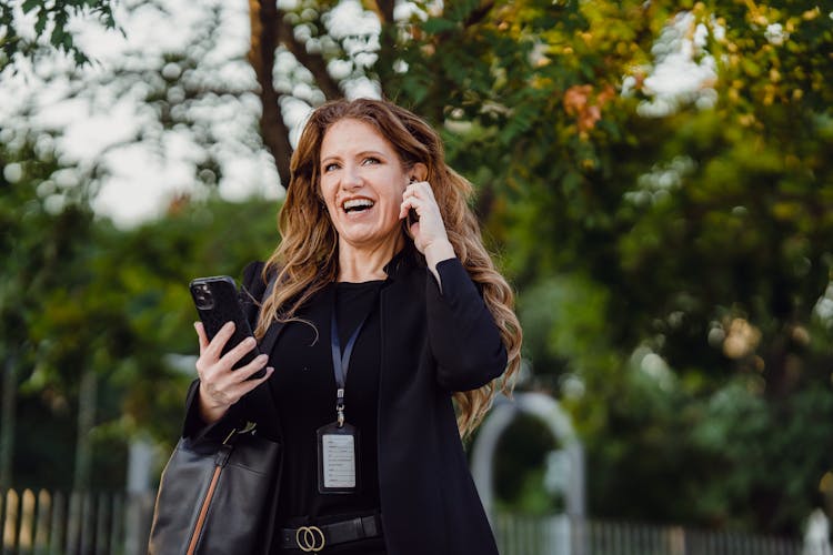 Smiling Businesswoman Talking On Cellphone Outdoors