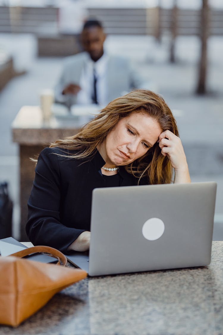 Photo Of Office Workers Using Laptops In The Yard