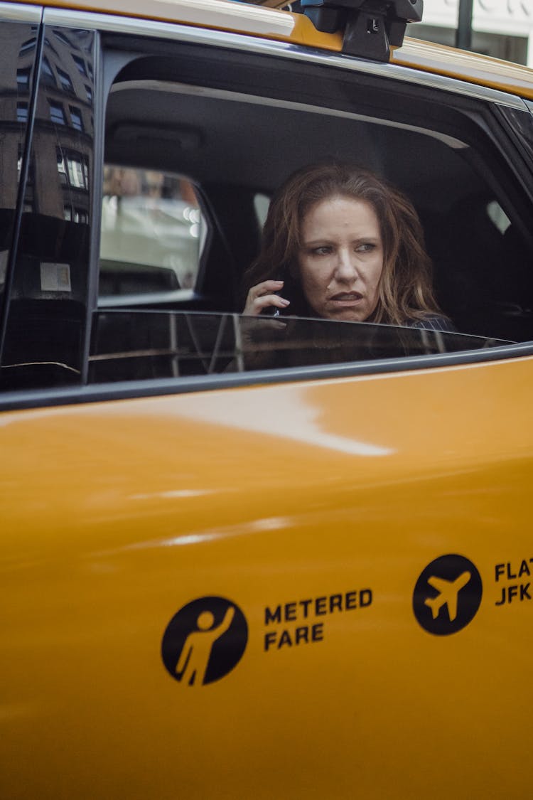 Woman Sitting In A Taxi And Talking On The Phone