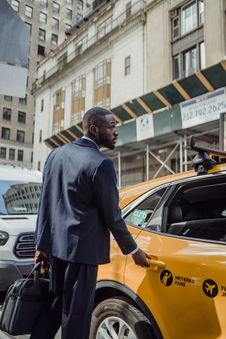 Man Getting Into The Taxi 