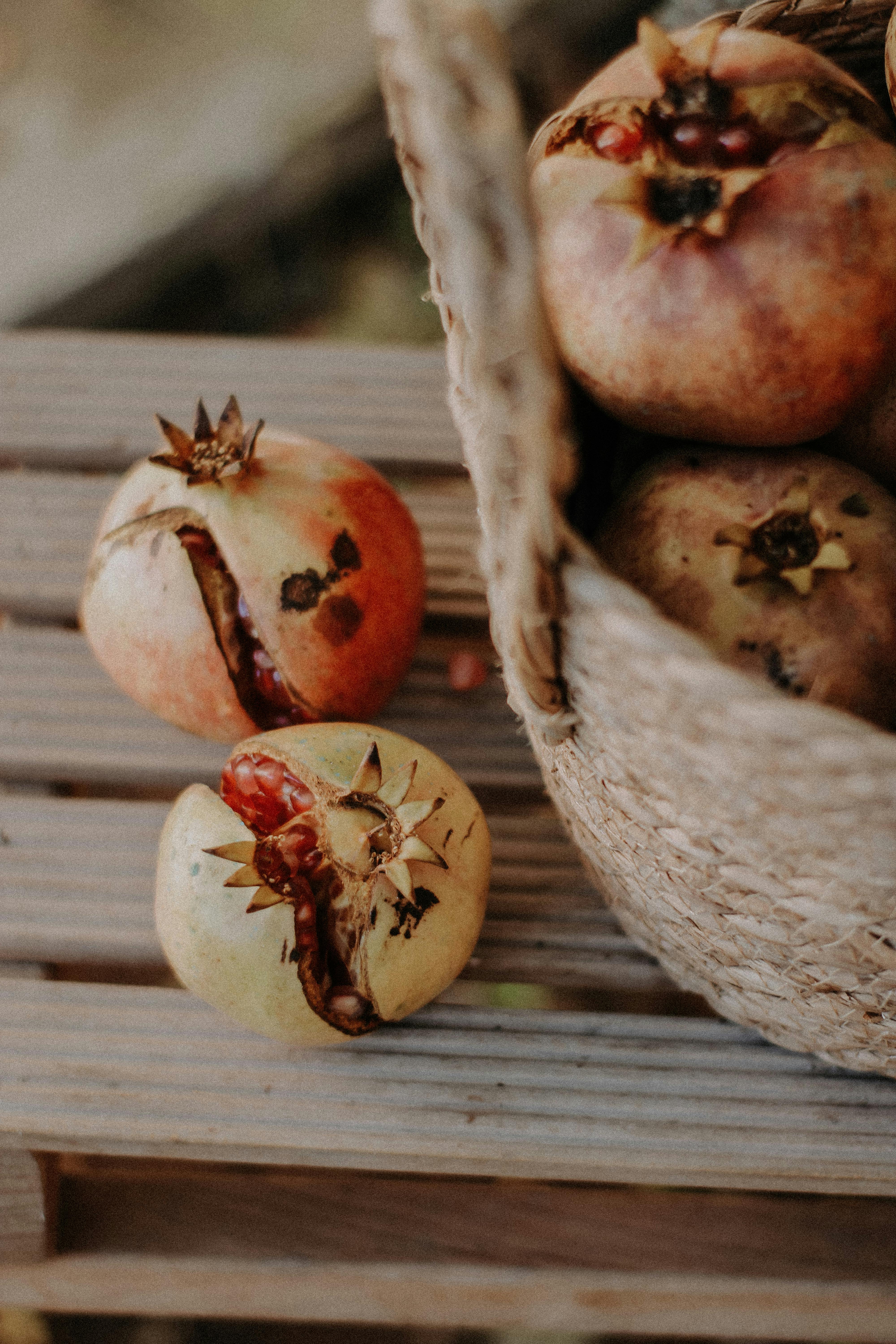 Delicious ripe pomegranates on a wooden surface offer a fresh and vibrant feel.