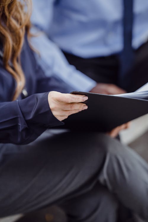 Woman Holding a Folder with Documents