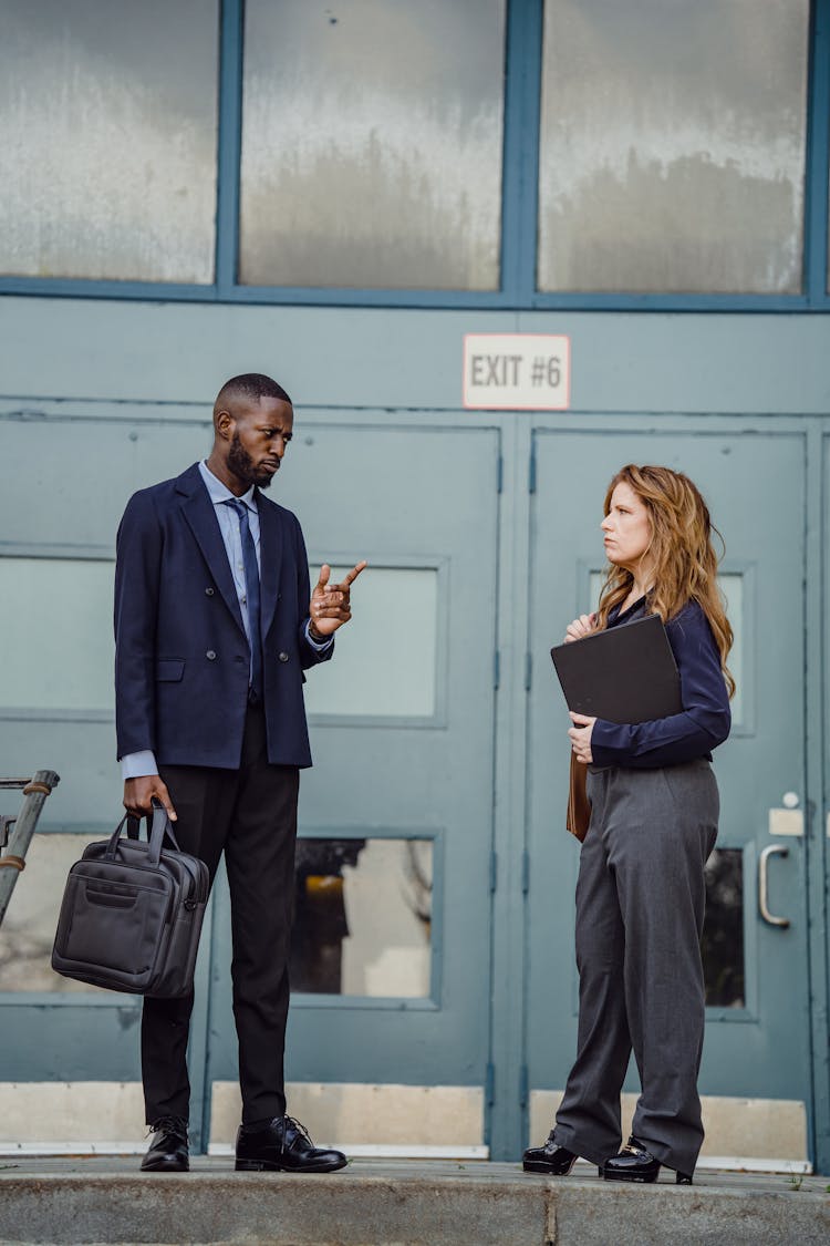 Coworkers Talking In Front Of A Building