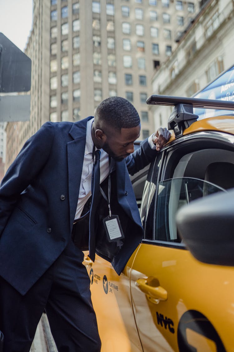 Man Looking At Taxi Window