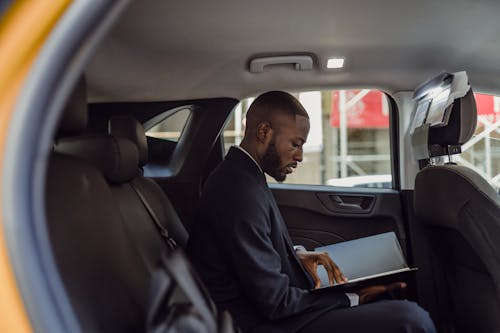 Man Sitting with Documents in Car 