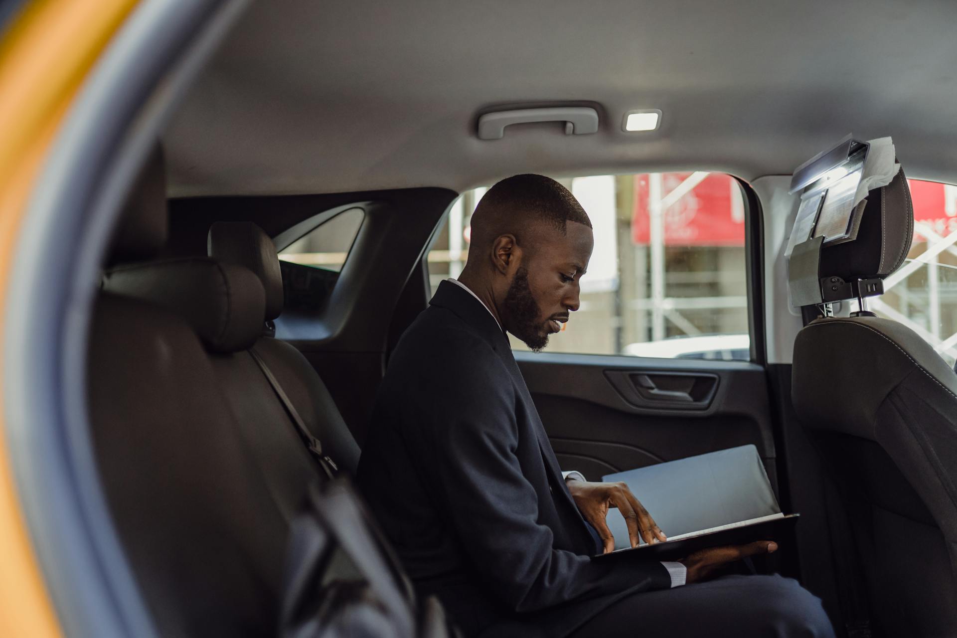 Man Sitting with Documents in Car