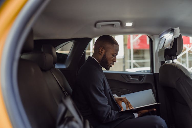 Man Sitting With Documents In Car 