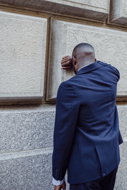 Man in Suit by Wall