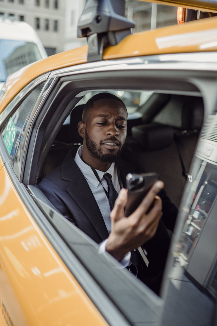 Man With Cellphone In Taxi