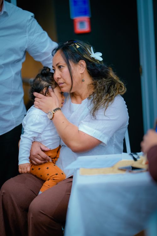 Free A touching indoor moment of an Asian woman embracing her baby, showcasing love and motherhood. Stock Photo