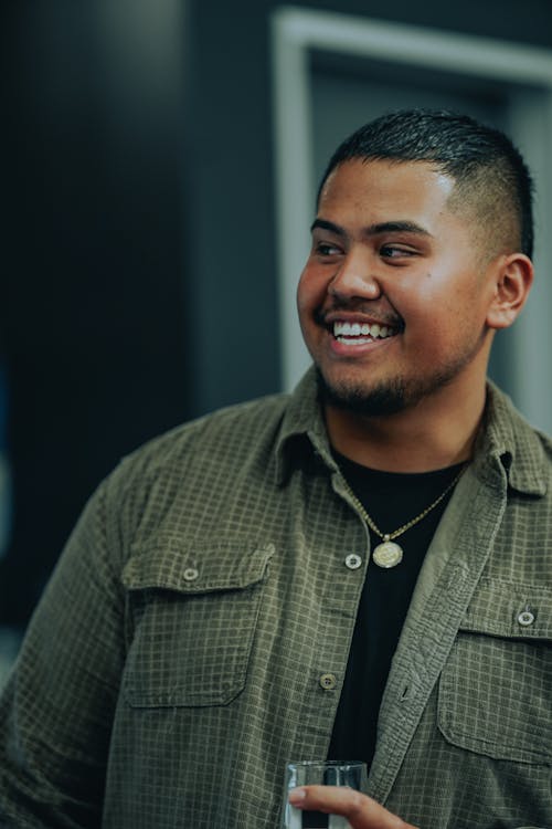 A Man Smiling While Looking Away