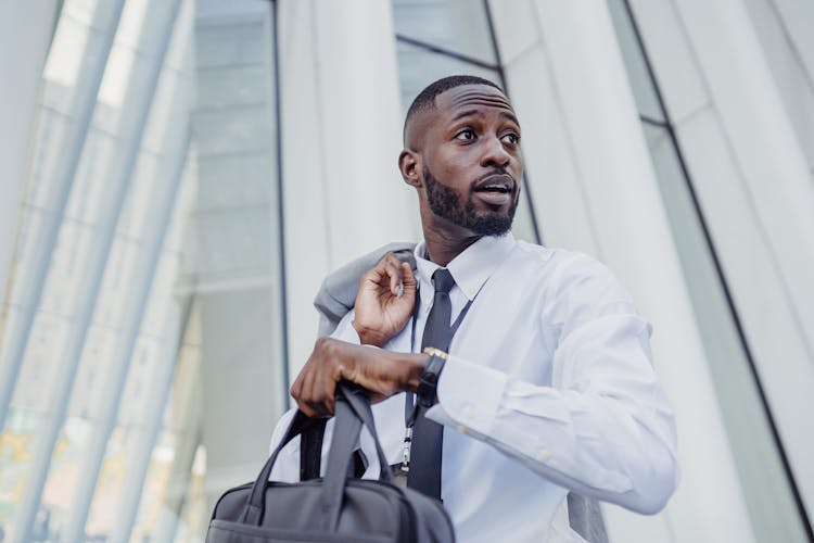 Man In Shirt Holding Bag