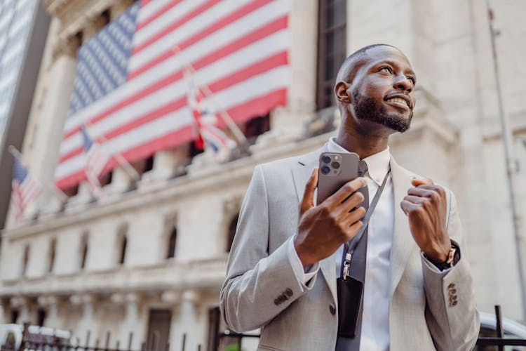 Man With Cellphone And Flags Behind