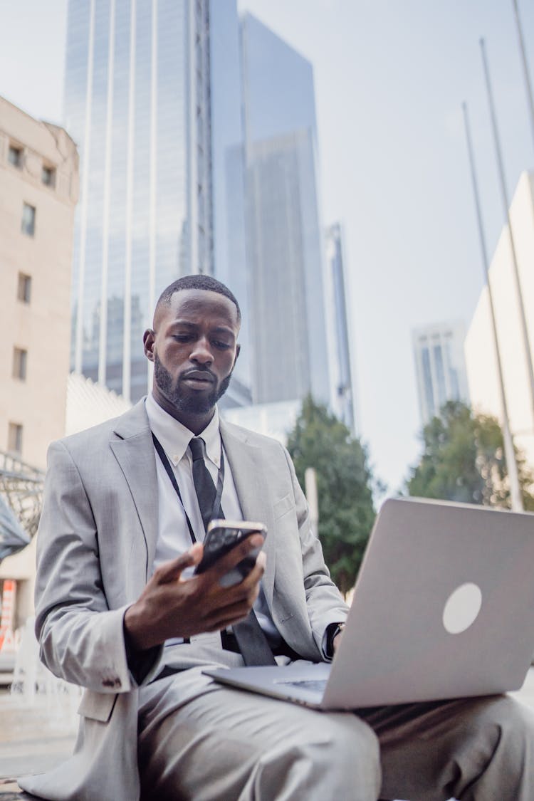 Man In Suit With Cellphone And Laptop