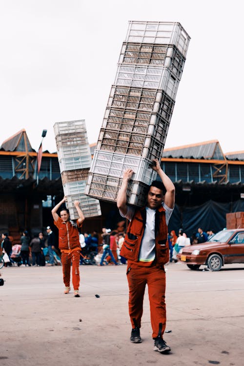 Men Carrying Plastic Containers from a Market