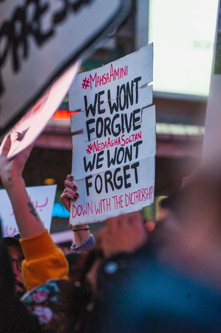 People Holding Posters