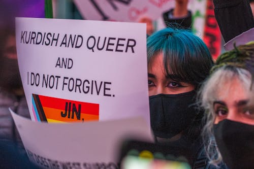 People Wearing Face Masks with a Protest Sign 