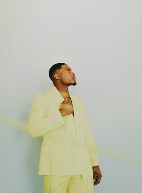  Young Man in a Yellow Suit Posing in Studio 