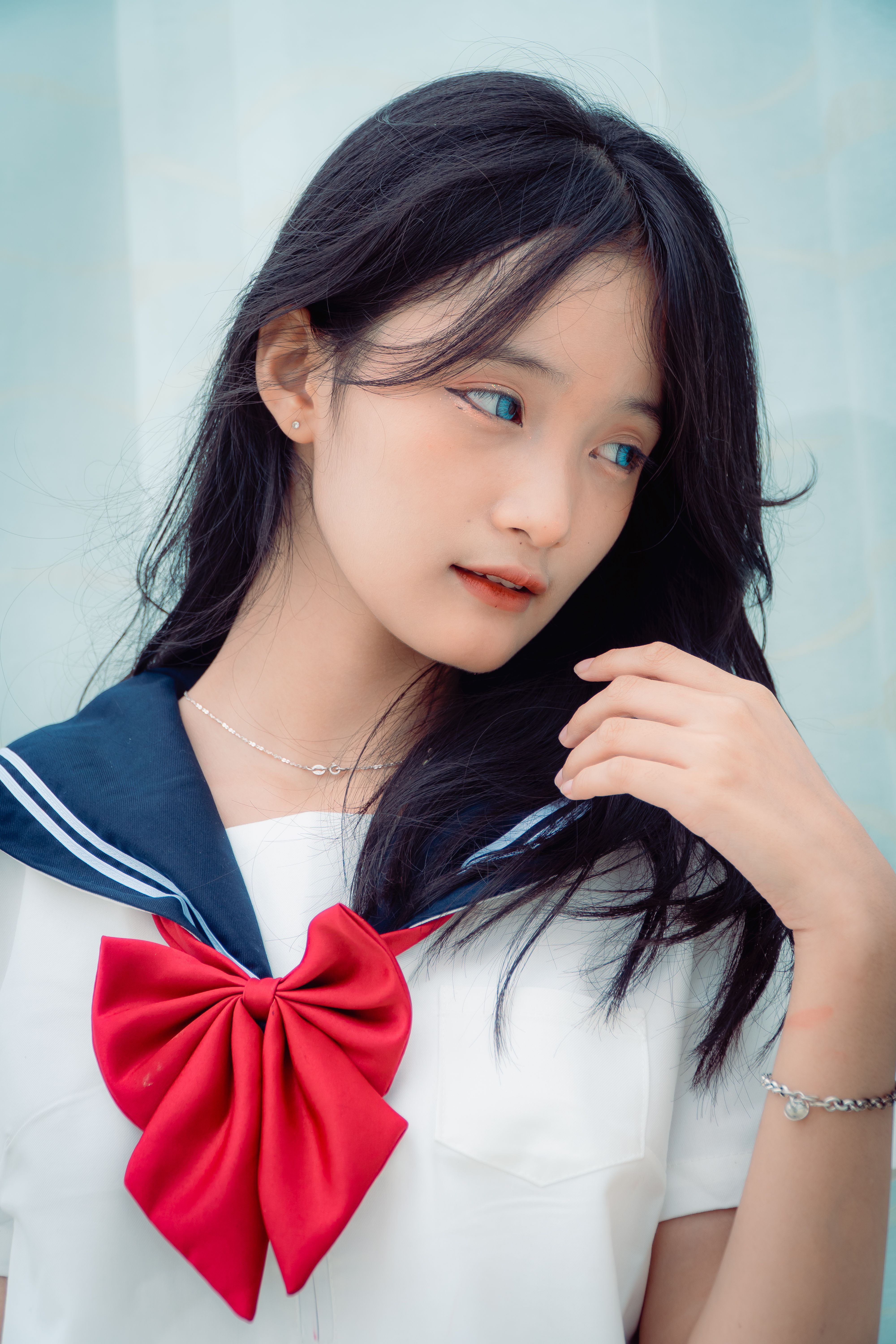 Charming portrait of a girl in a sailor suit with a red bow, exuding elegance.