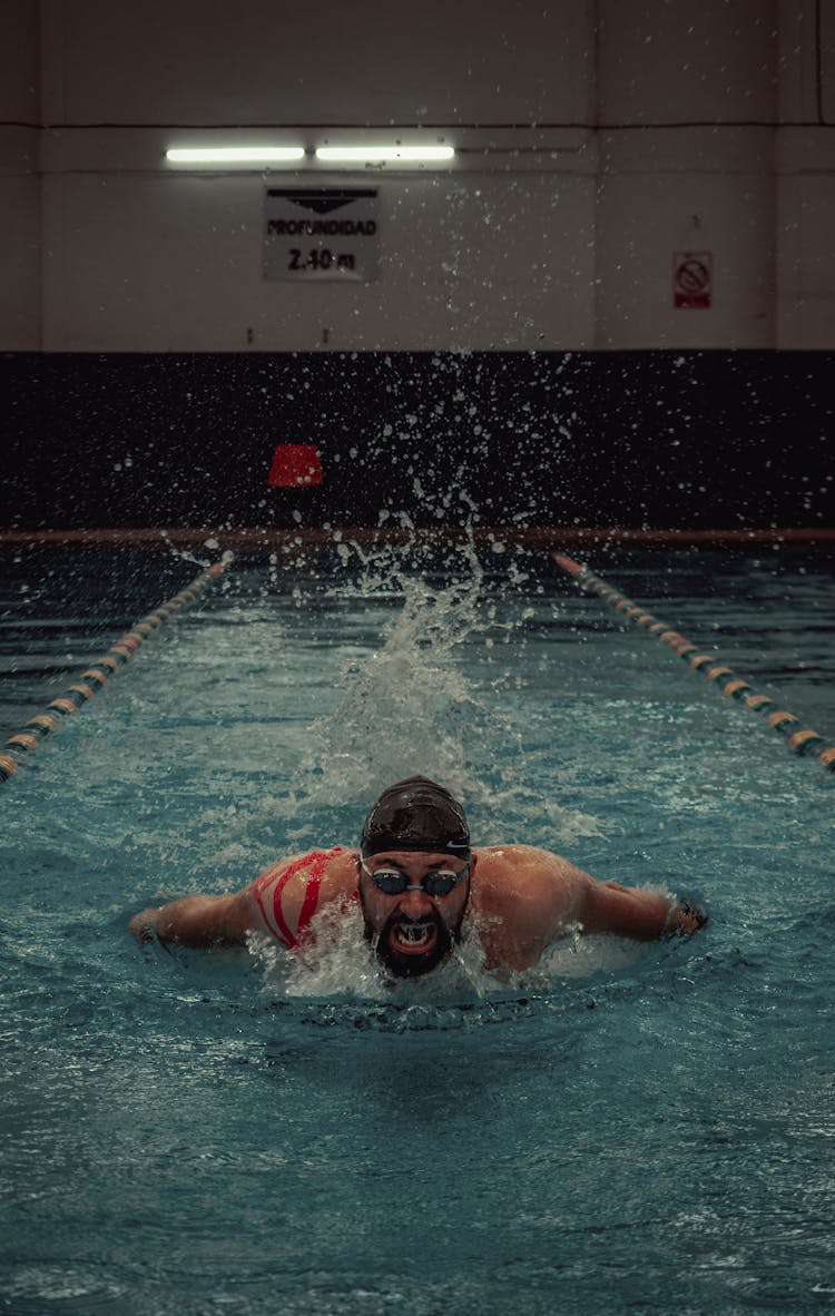 A Man Swimming In The Pool